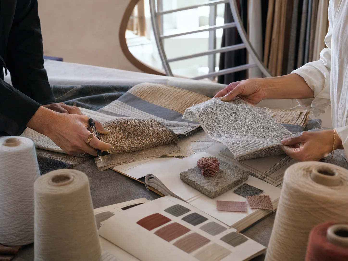 Posh textile designers reviewing fabric samples and project materials